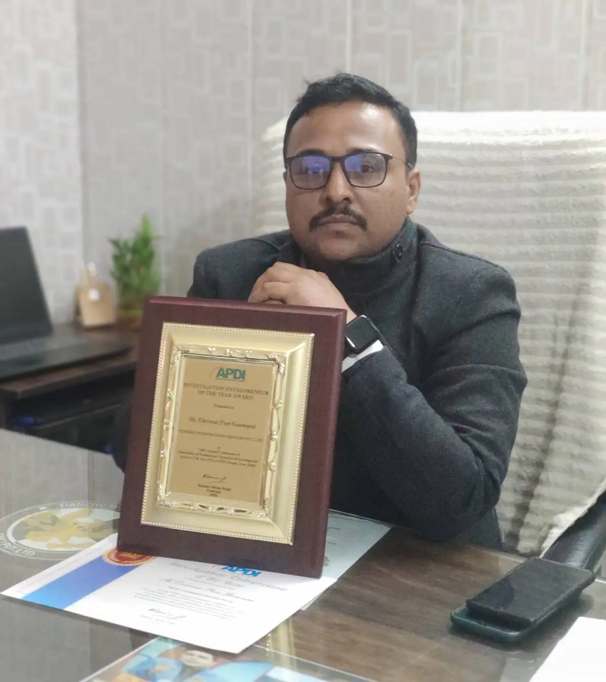 Chhattisgarh Detective Services agency owner with award at office.